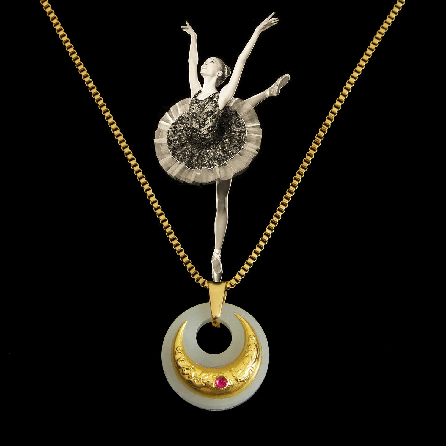 Necklace with a ballerina pendant and gold chain on a black background