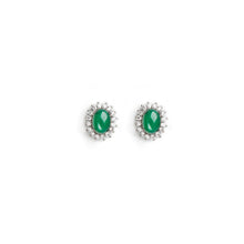 Pair of green gemstone earrings on a white background.