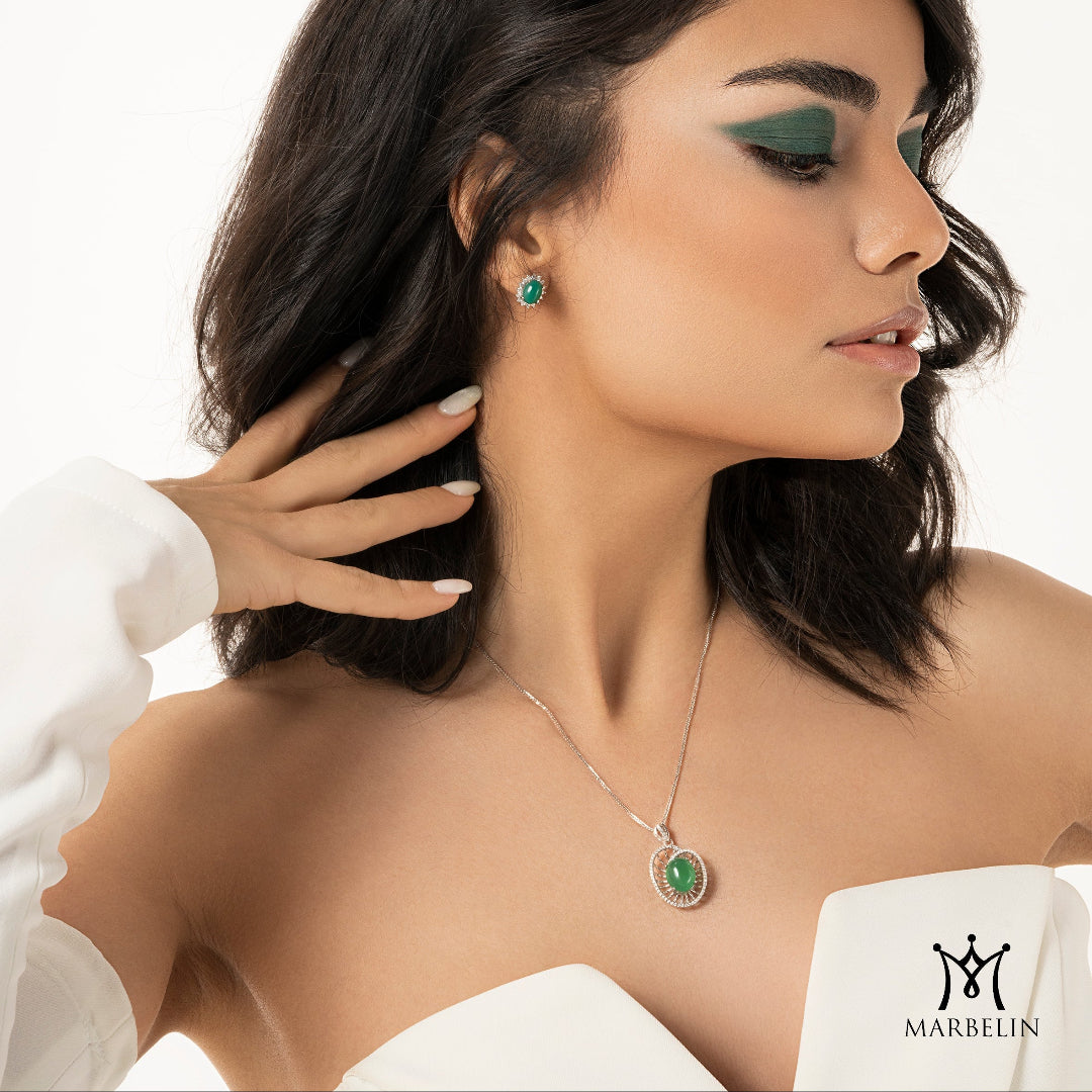 Woman wearing a necklace and earrings with a white background, featuring the Marbelin brand.