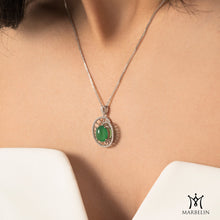 Green pendant necklace on a model with 'Marbelin' branding.
