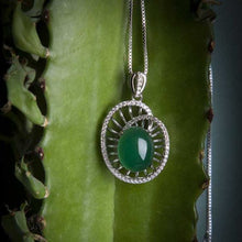 Green pendant necklace on a green cactus