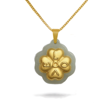 Gold necklace with a clover-shaped pendant on a white background